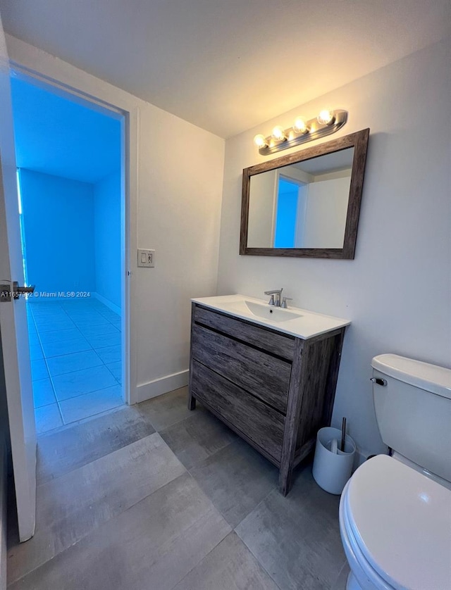 bathroom with tile patterned floors, toilet, and vanity