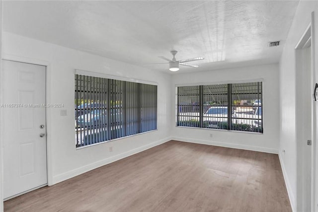 empty room featuring ceiling fan and hardwood / wood-style flooring