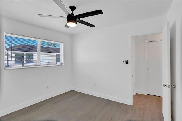 spare room featuring hardwood / wood-style floors and ceiling fan