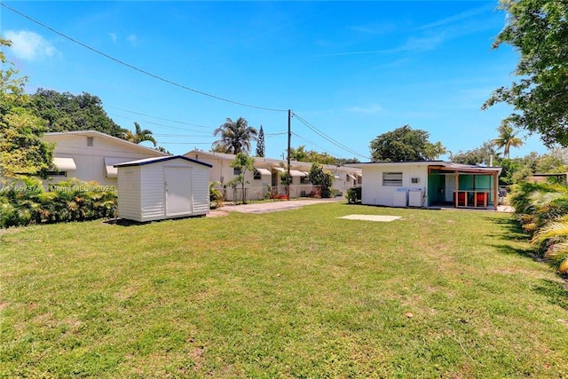 view of yard featuring a storage shed and a patio