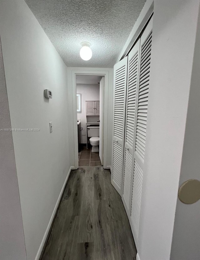 13499 Biscayne Blvd Unit 1205, North Miami, FL 33181 - hall with wood finished floors, a textured ceiling, and baseboards
