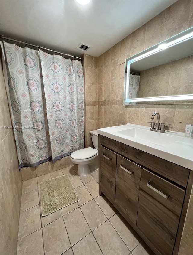 13499 Biscayne Blvd Unit 1205, North Miami, FL 33181 - bathroom featuring tile walls, toilet, tile patterned flooring, vanity, and curtained shower