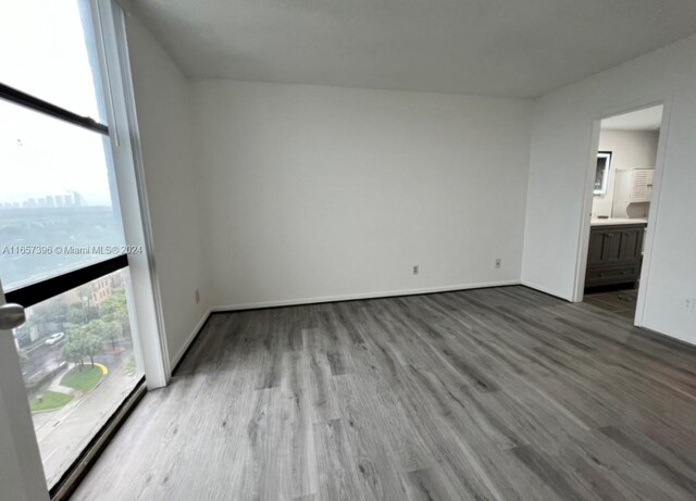 13499 Biscayne Blvd Unit 1205, North Miami, FL 33181 - spare room with wood finished floors and baseboards