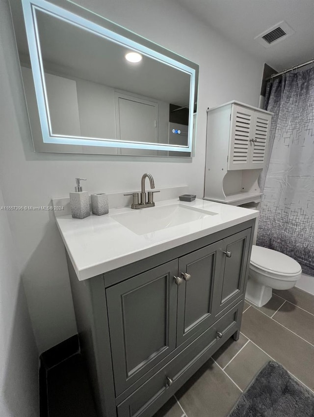 bathroom featuring vanity, toilet, a shower with shower curtain, and tile patterned flooring