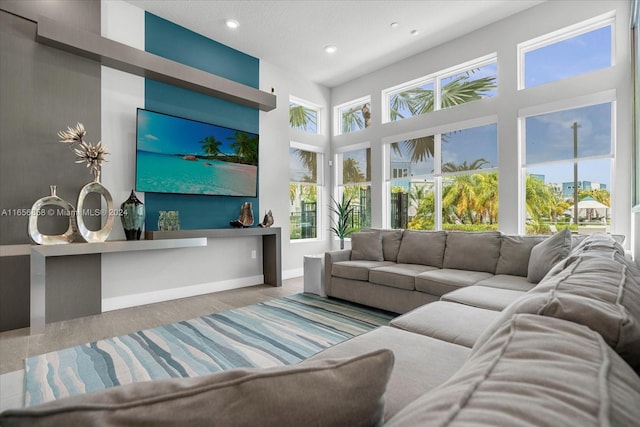 living room featuring a towering ceiling