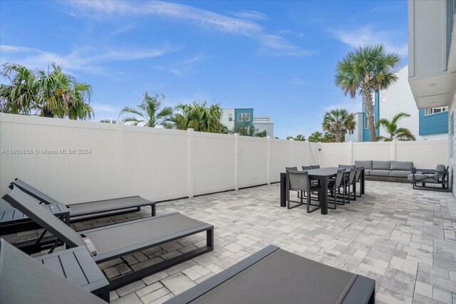 7740 Sandy Ridge Dr Unit 112, Kissimmee, FL 34747 - view of patio / terrace with outdoor dining space, an outdoor living space, and a fenced backyard