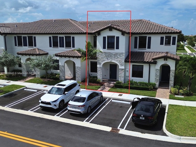 mediterranean / spanish-style home featuring a front lawn