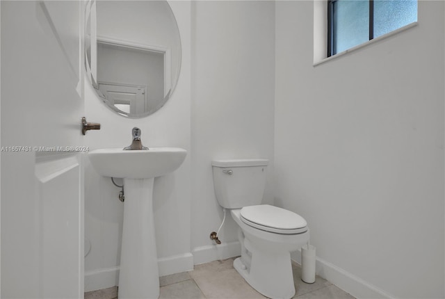 bathroom with toilet and tile patterned floors