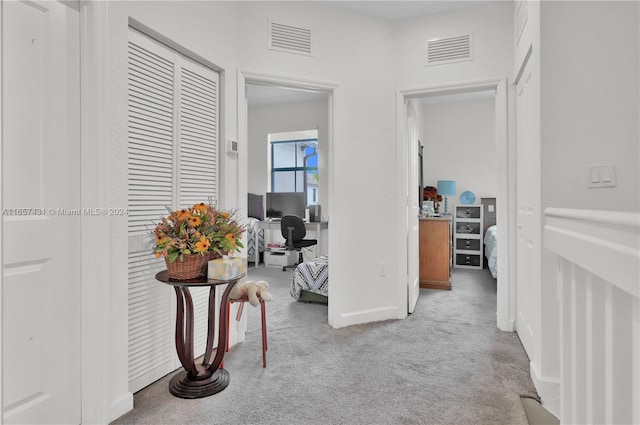 hall featuring light colored carpet