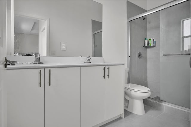 bathroom with tile patterned flooring, walk in shower, toilet, and vanity