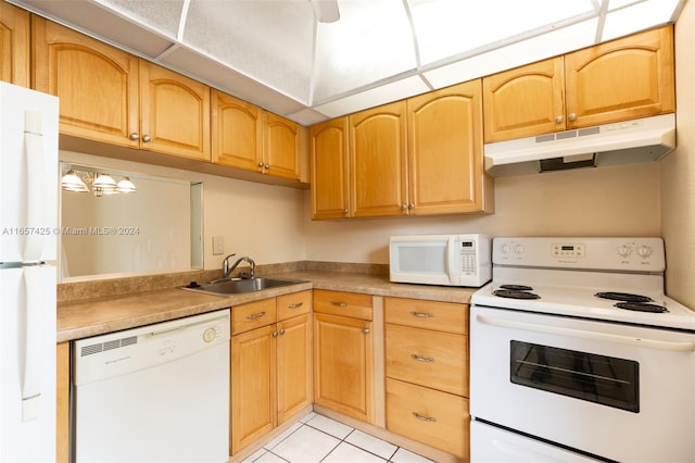 kitchen with white appliances, sink, and light tile patterned floors