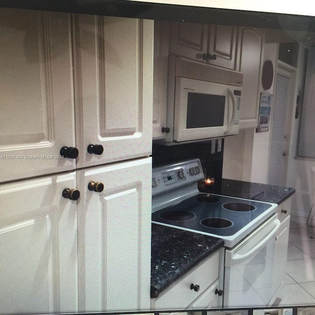 kitchen with tile patterned floors, tile countertops, and white appliances