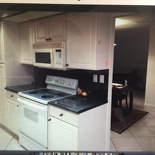 kitchen featuring white appliances and light tile patterned flooring