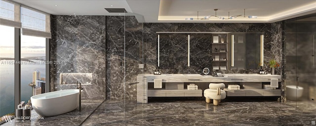 bathroom with vanity, tile walls, and a tub