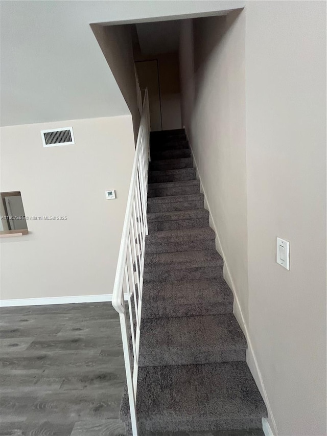 stairs with hardwood / wood-style flooring