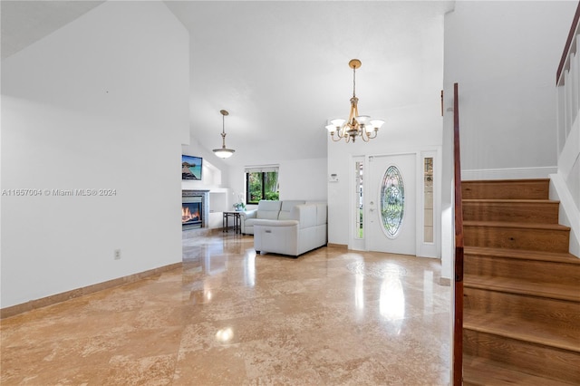 entryway with a notable chandelier and high vaulted ceiling