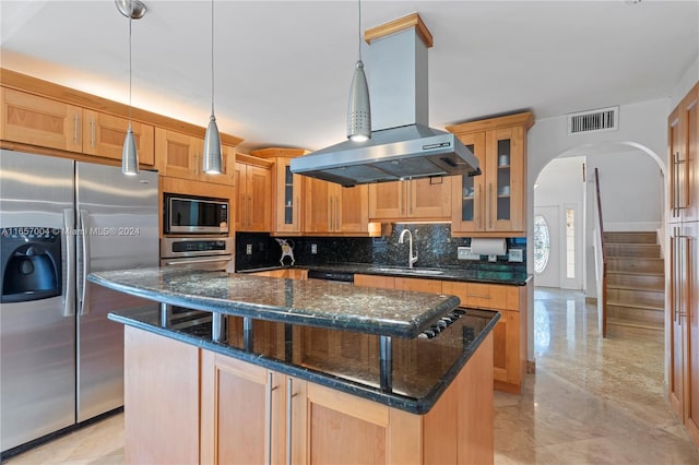 kitchen featuring a center island, dark stone countertops, stainless steel appliances, and island exhaust hood