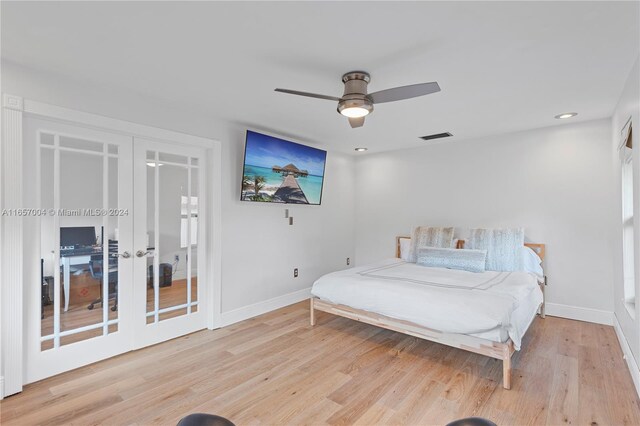 bedroom featuring ceiling fan, light wood-type flooring, and french doors