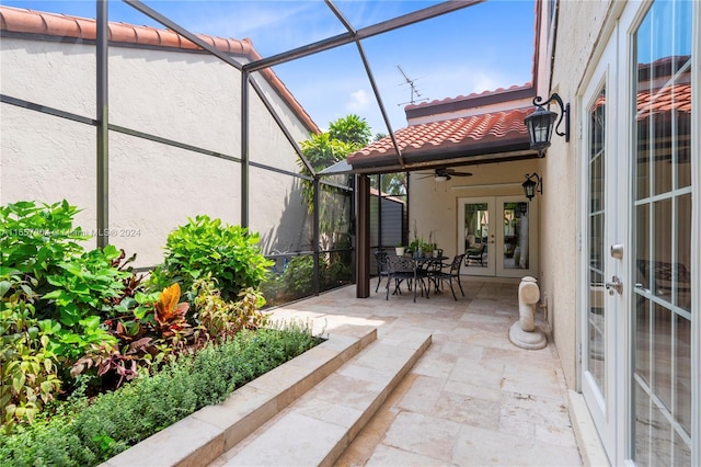 view of patio / terrace with french doors, glass enclosure, and ceiling fan