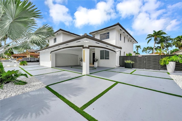 back of property featuring a garage and a patio area