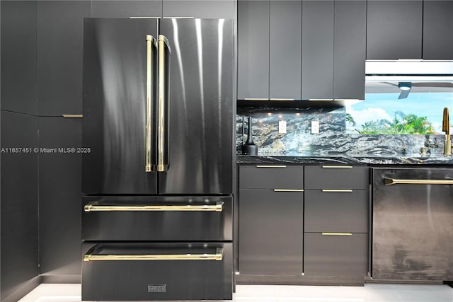 kitchen with tasteful backsplash, high quality fridge, and dark stone counters