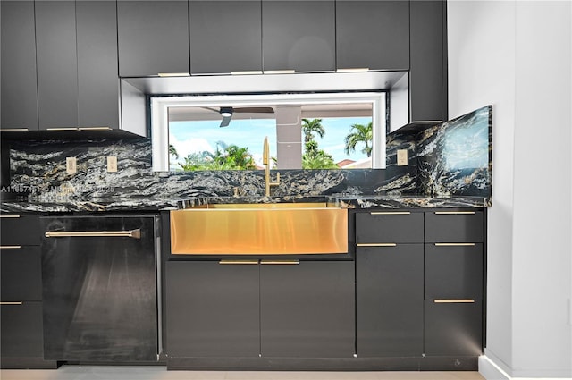 kitchen featuring plenty of natural light, sink, backsplash, and dark stone counters