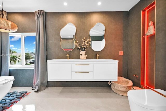 bathroom with toilet, vanity, and concrete flooring