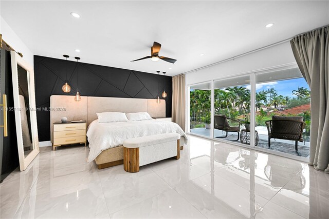 bedroom featuring a barn door, ceiling fan, a closet, and a spacious closet