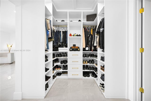 spacious closet with light tile patterned floors