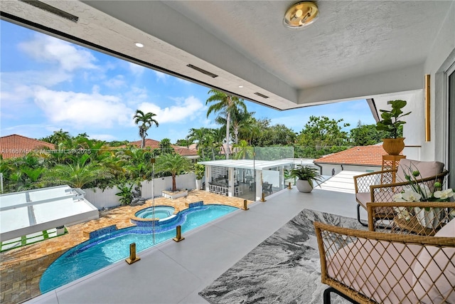 view of swimming pool featuring an in ground hot tub