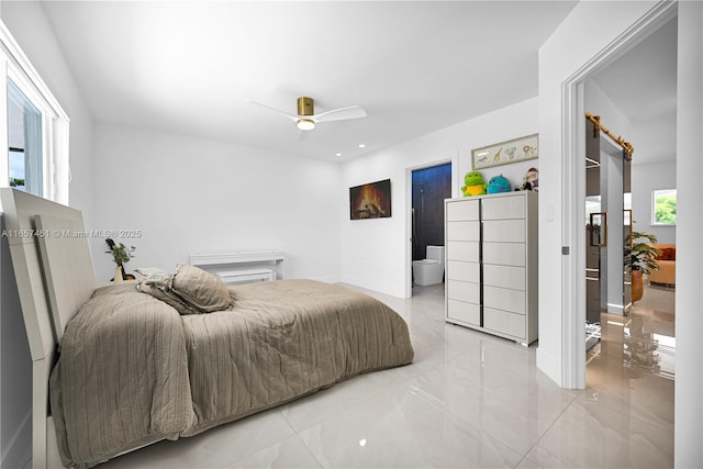 bedroom with a barn door and ceiling fan