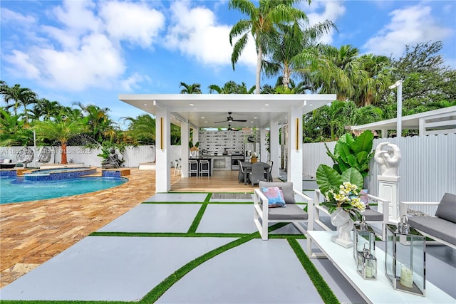 exterior space with ceiling fan, pool water feature, and a pool with hot tub