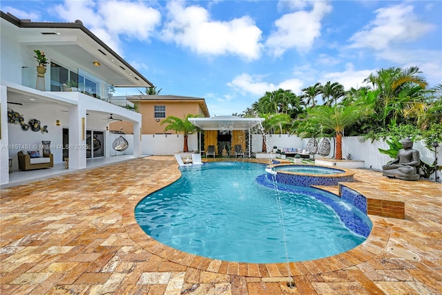 view of pool featuring an in ground hot tub, pool water feature, ceiling fan, and a patio