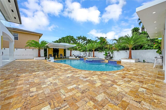 view of pool featuring an in ground hot tub and a patio