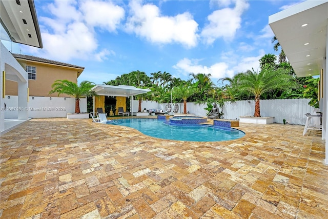 view of pool featuring an in ground hot tub and a patio