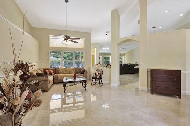 living room with a high ceiling and ceiling fan