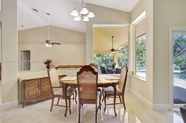 dining room with ceiling fan with notable chandelier, a wealth of natural light, and vaulted ceiling