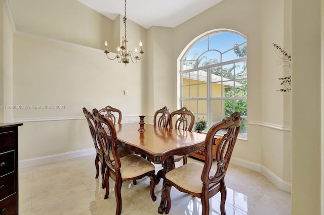 dining space with crown molding, light tile patterned floors, and a notable chandelier