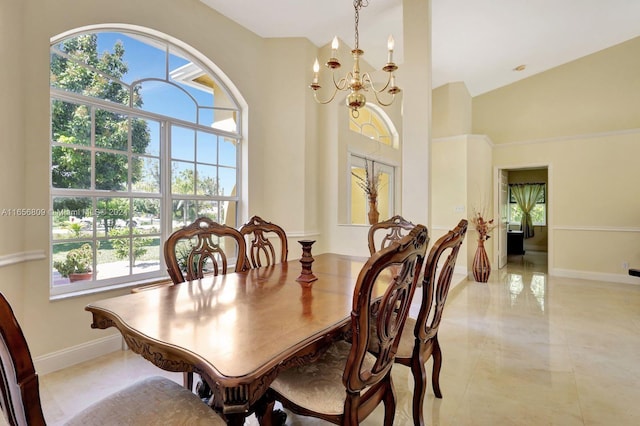 dining room featuring high vaulted ceiling and a chandelier