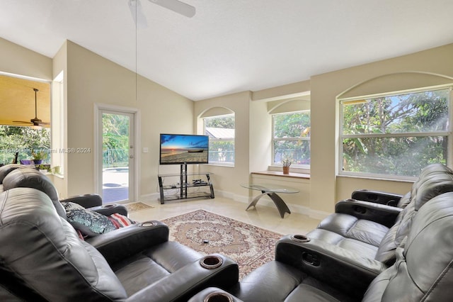 tiled living room with ceiling fan, a wealth of natural light, and vaulted ceiling