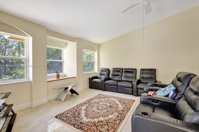 tiled living room featuring lofted ceiling, ceiling fan, and a textured ceiling