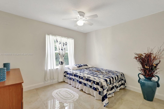 tiled bedroom featuring ceiling fan