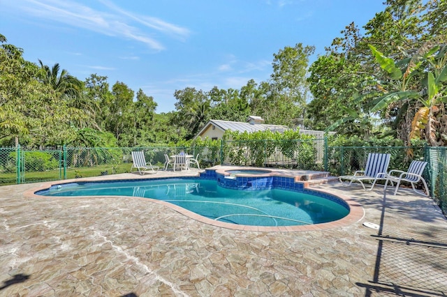 view of swimming pool featuring an in ground hot tub and a patio area