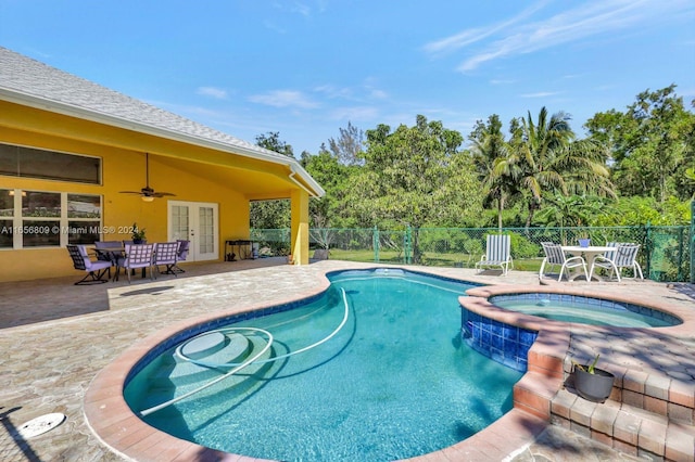 view of swimming pool featuring ceiling fan, a patio, an in ground hot tub, and french doors