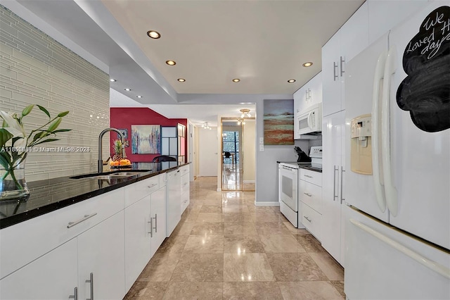 kitchen with white appliances, sink, white cabinets, and tasteful backsplash