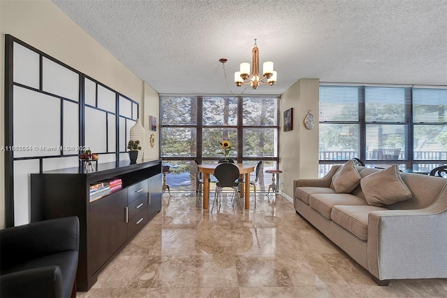 living room featuring a wall of windows, a notable chandelier, and a textured ceiling