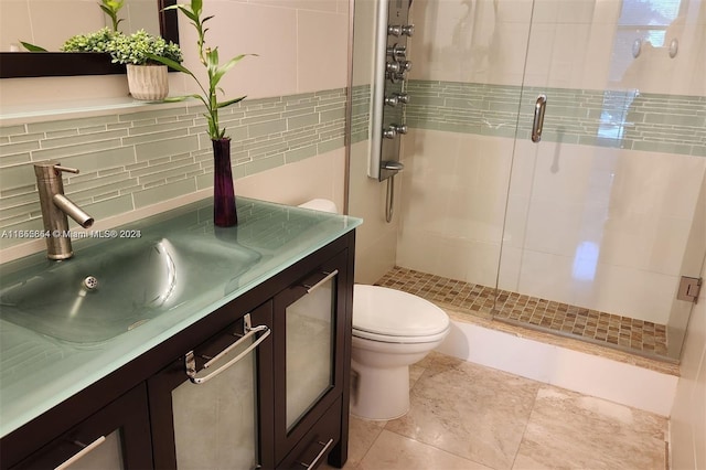 bathroom featuring vanity, toilet, decorative backsplash, and walk in shower