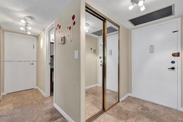 hallway with a textured ceiling