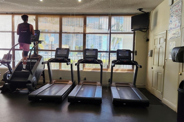 exercise room featuring a textured ceiling