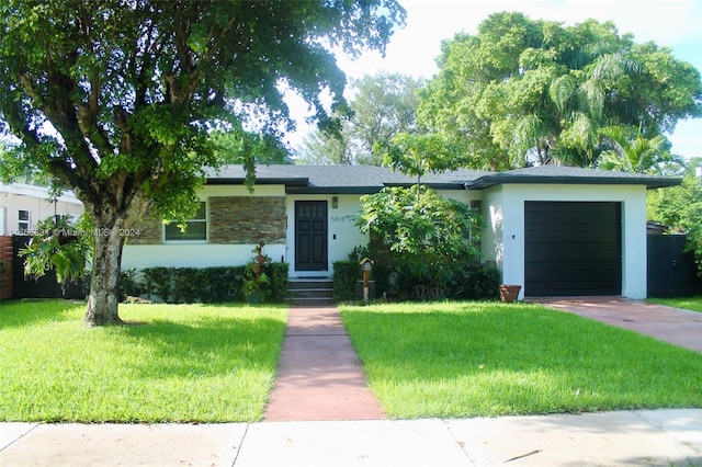 ranch-style home with a garage and a front yard